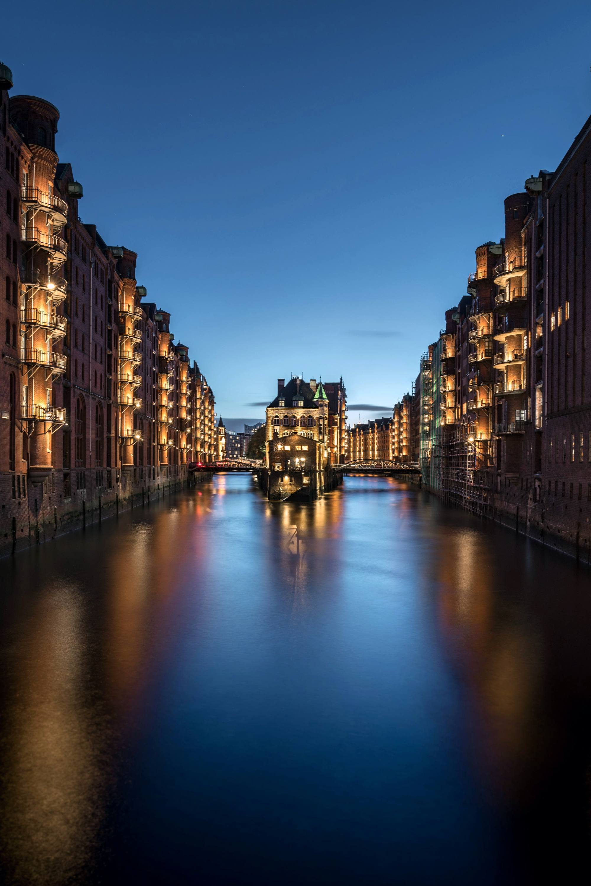 Warehouses along a canal lit up at night