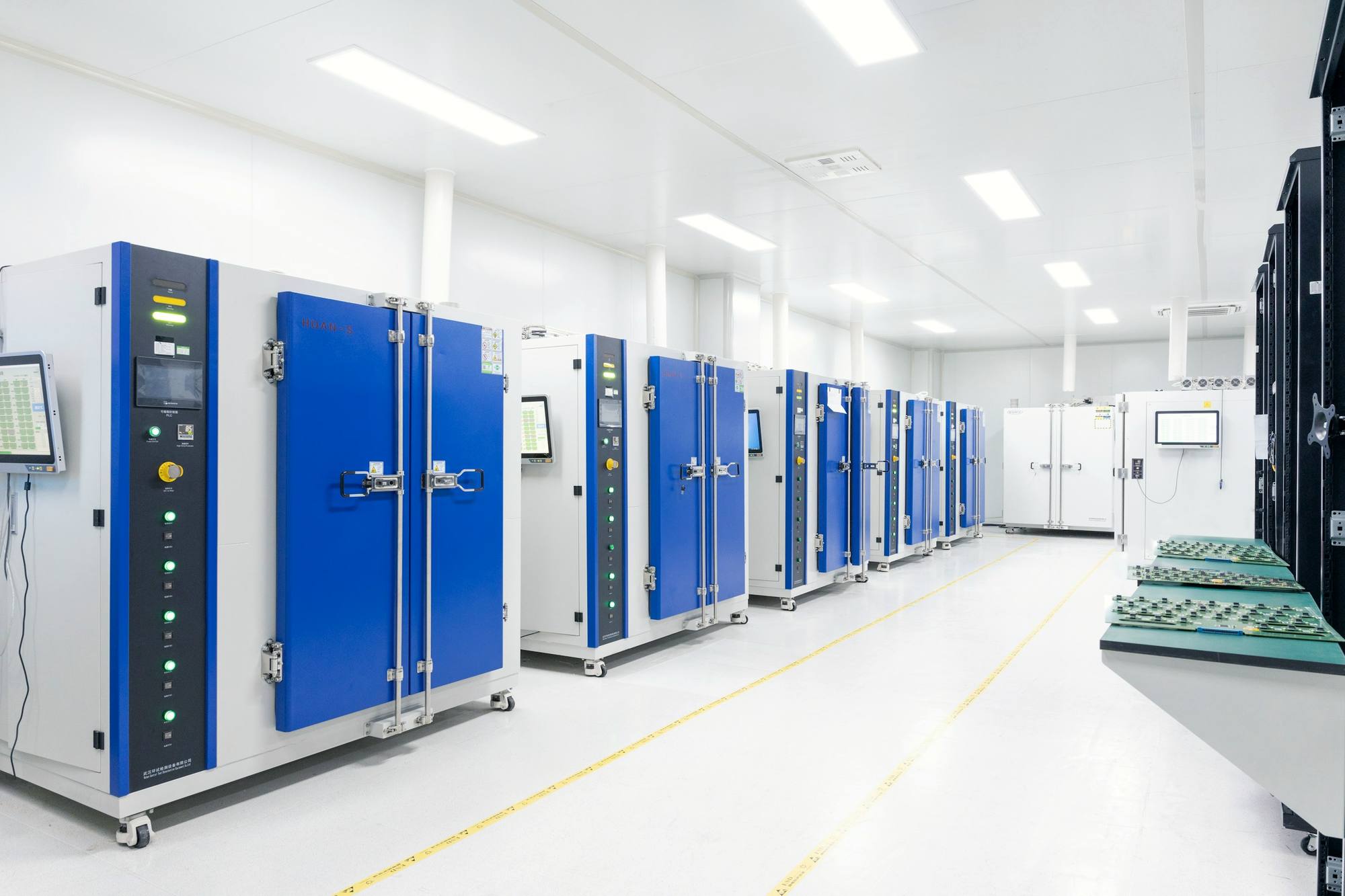 A bright, white data centre with rows of blue server cabinets