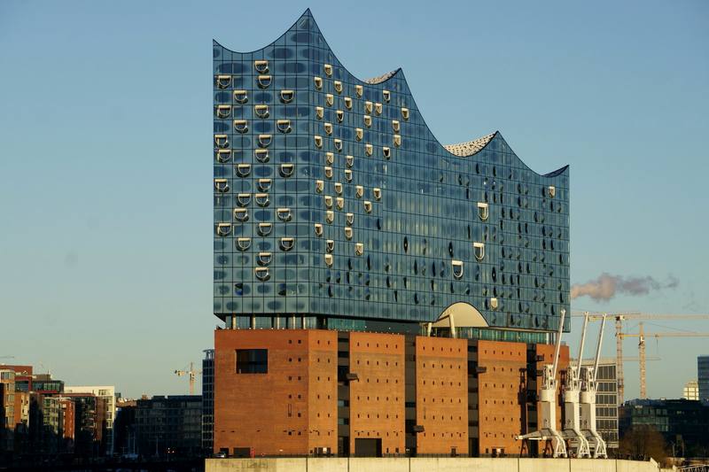 The Elbphilharmonie in Hamburg, its glass wave rising above a brick warehouse