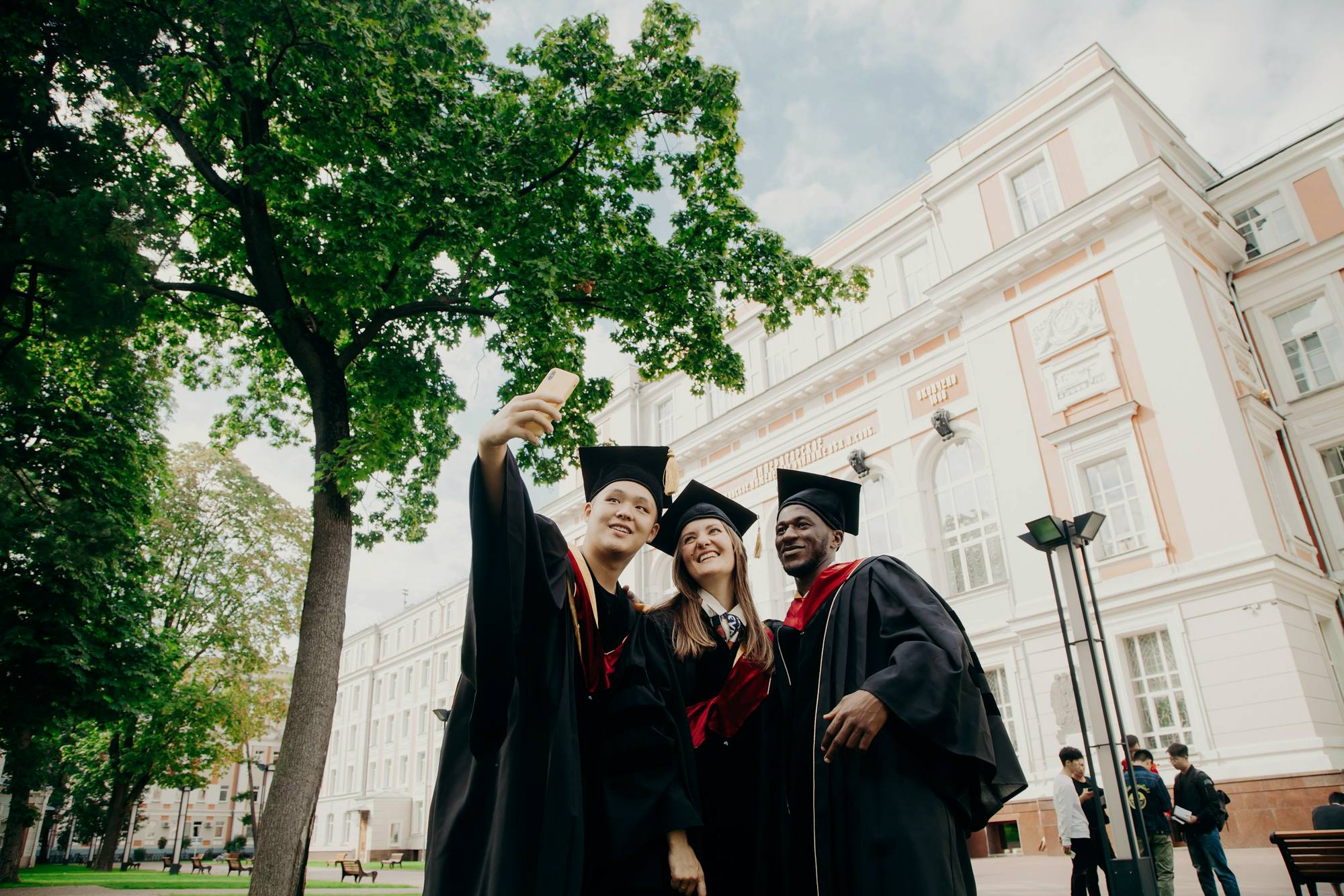 Graduates in gowns taking a photo together