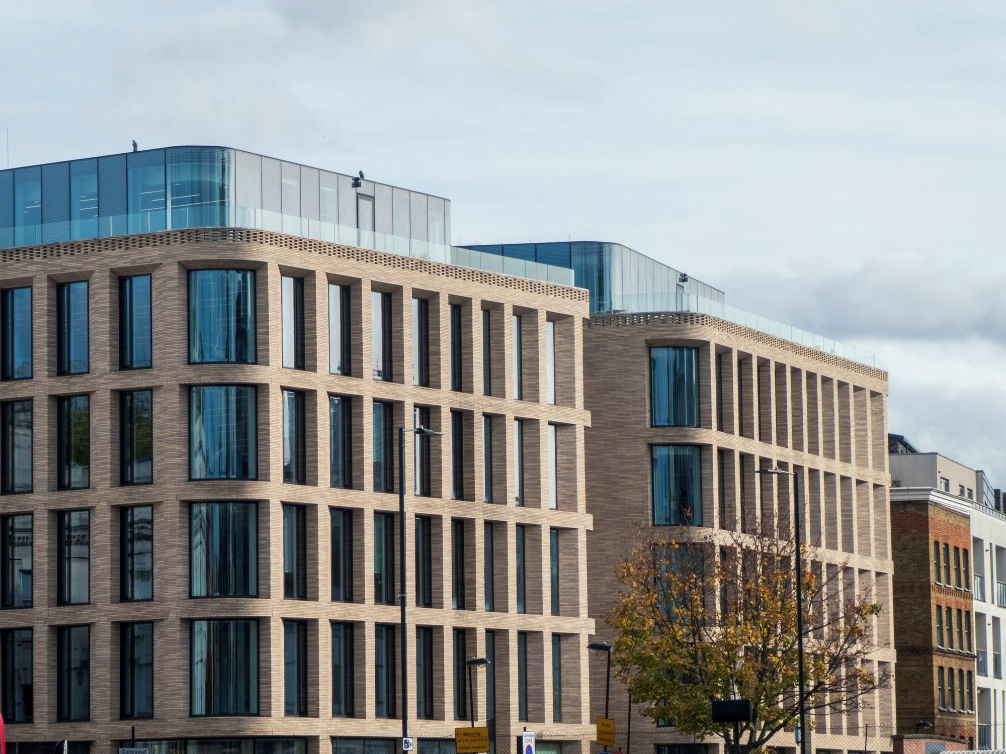 The warm stone facade of a modern office building