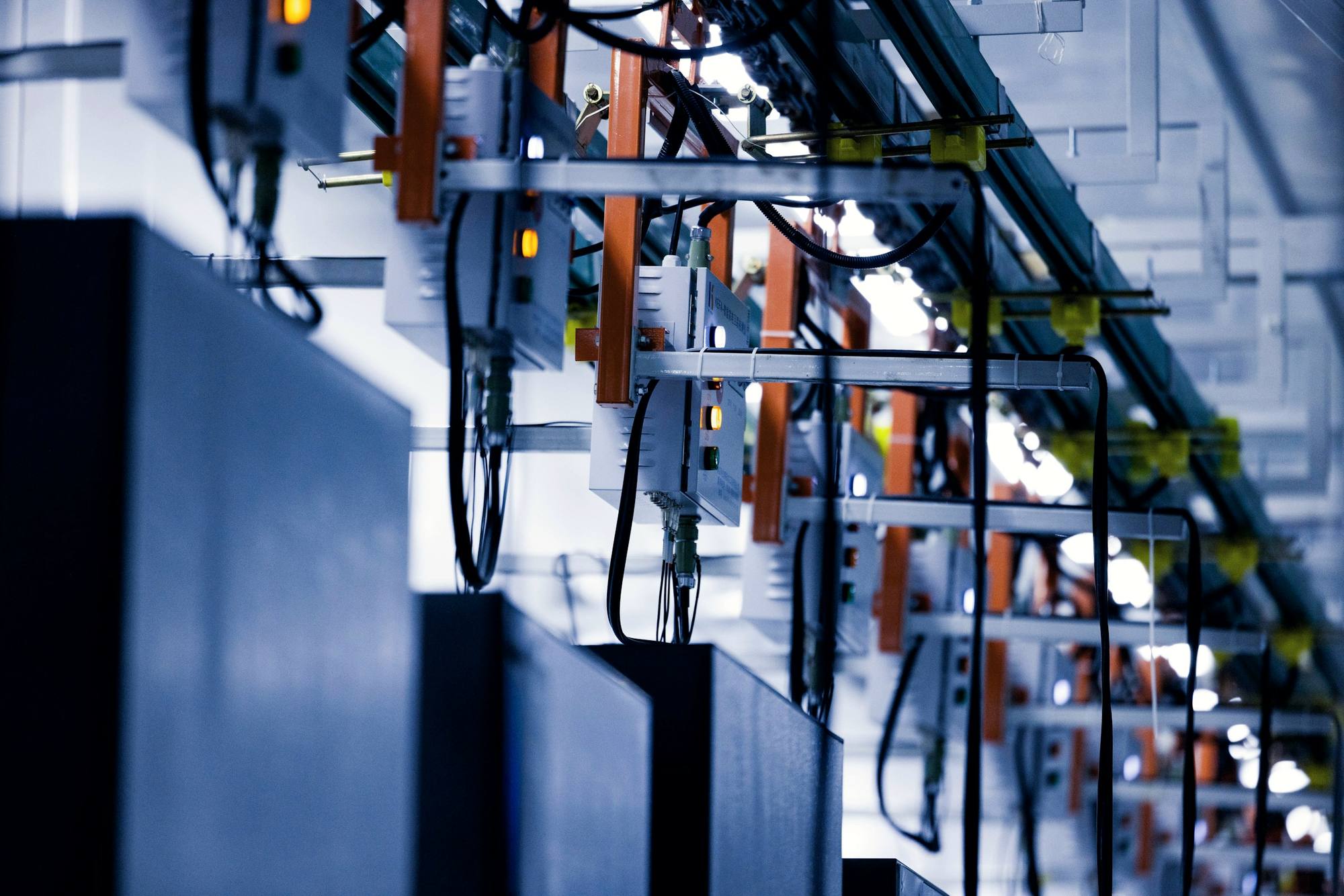 Rows of server racks with neatly routed cables in a bright data centre