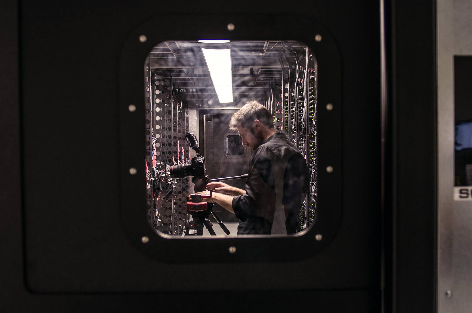 A technician working on server equipment with a screwdriver